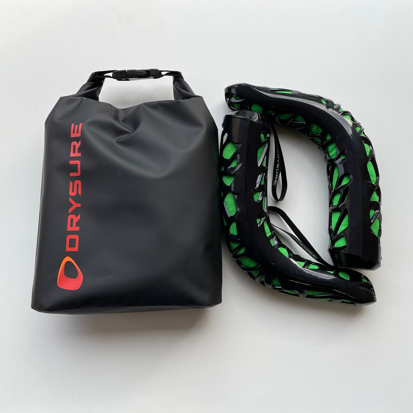 Large Dry bag with orange drysure logo next to Drysure Extreme boot dryers in black and Green
