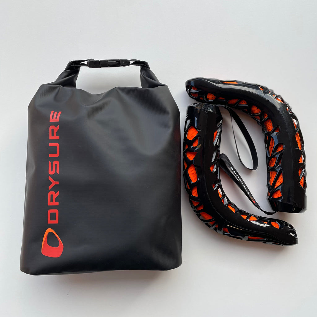 Large Dry bag with orange drysure logo next to Drysure Extreme boot dryers in black and orange