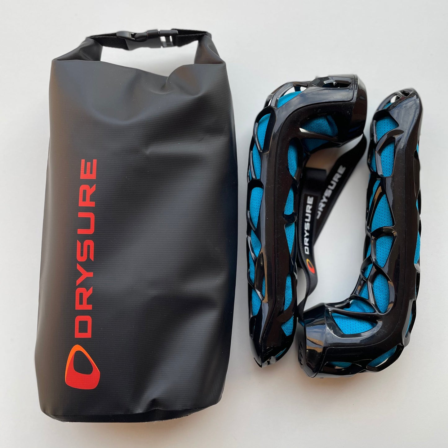 Small Dry bag with orange drysure logo next to Drysure Active shoe dryers in black and blue